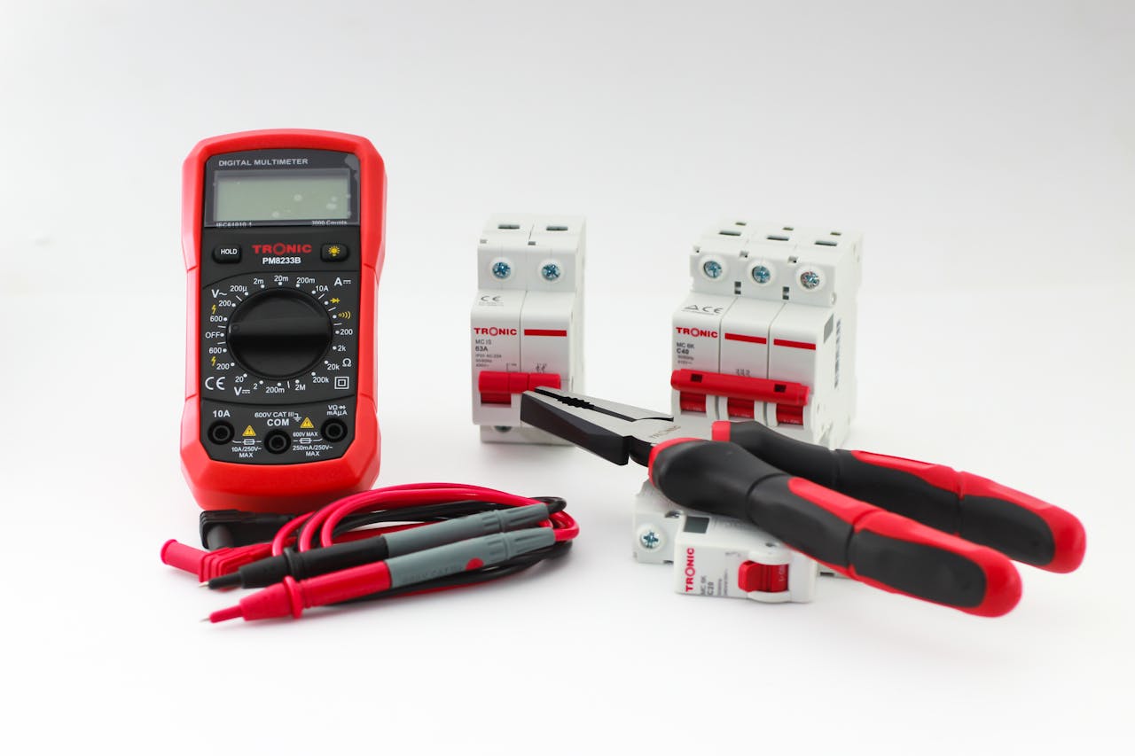 Crafting Captivating Headlines: Your awesome post title goes here Close-up of a digital multimeter with electrical tools and circuit breakers on a white background.